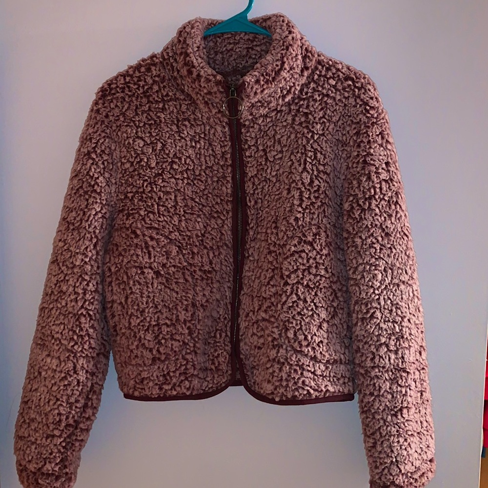 Small Fur jacket, zip up, 2 pockets and no hood.